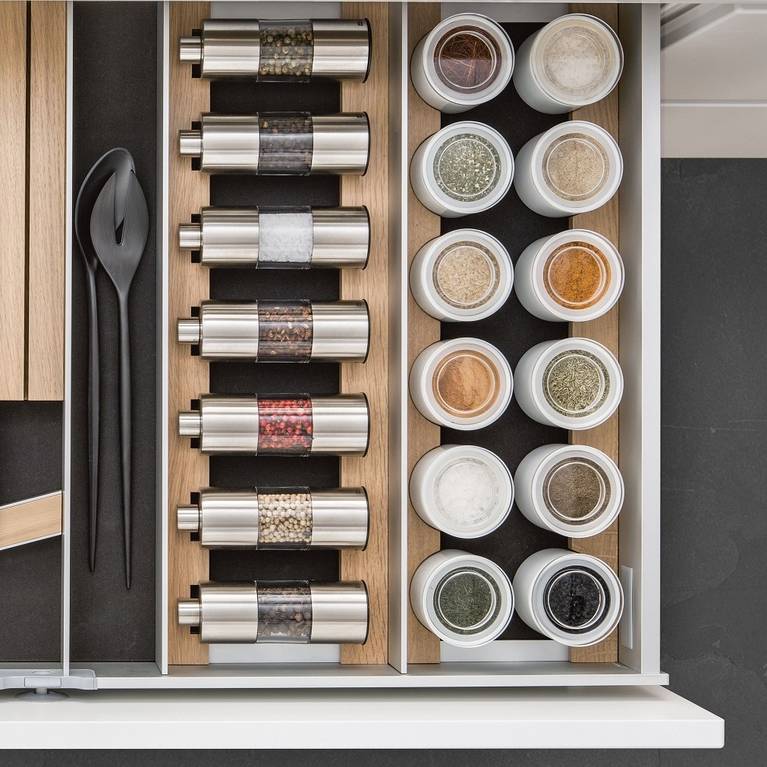 SieMatic Aluminum Interior Accessories in light oak offer space for spice mills, porcelain jars and knives.